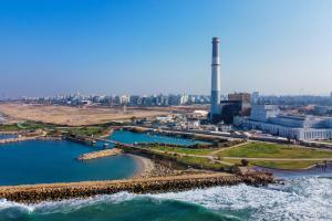 Clear-sky-over-city-with-factory-on-shore